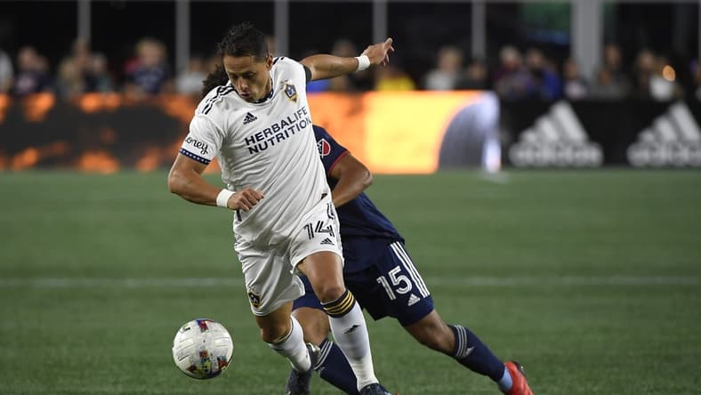 Aug 28, 2022; Foxborough, Massachusetts, USA; Los Angeles Galaxy forward Javier Hernandez (14) controls the ball while New England Revolution midfielder Brandon Bye (15) defends during the first half at Gillette Stadium. Mandatory Credit: Bob DeChiara-USA TODAY Sports