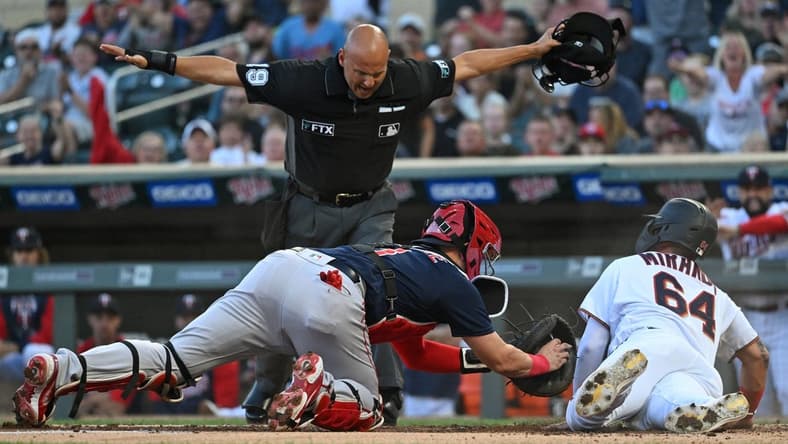 Aug 30, 2022; Minneapolis, Minnesota, USA; Minnesota Twins designated hitter Jose Miranda (64) scores a run ahead of the tag by Boston Red Sox catcher Reese McGuire (3) on a double hit by outfielder Nick Gordon (not pictured) during the first inning at Target Field. Mandatory Credit: Nick Wosika-USA TODAY Sports