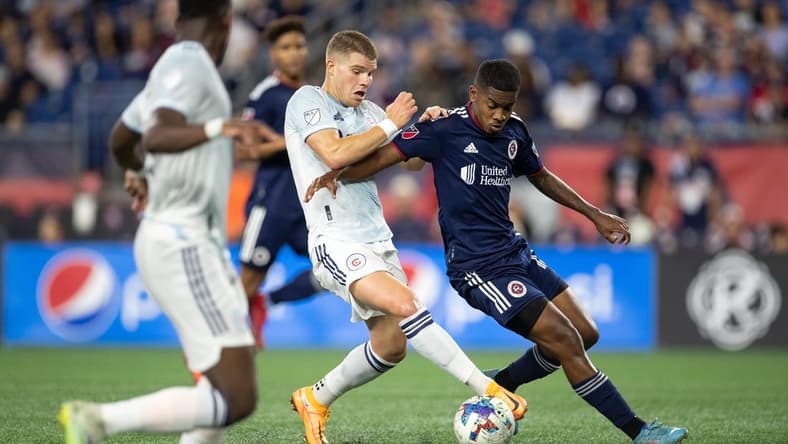 Aug 31, 2022; Foxborough, Massachusetts, USA; New England Revolution midfielder Maciel (13) defends Chicago Fire FC forward Christopher Mueller (8) during the first half at Gillette Stadium. Mandatory Credit: Paul Rutherford-USA TODAY Sports