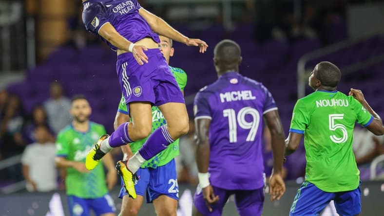 Aug 31, 2022; Orlando, Florida, USA;  Orlando City forward Ercan Kara (9) heads the ball against the Seattle Sounders in the second half at Exploria Stadium. Mandatory Credit: Nathan Ray Seebeck-USA TODAY Sports