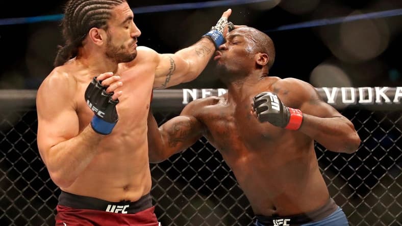 May 4, 2019; Ottawa, ON, Canada; Derek Brunson (red gloves) fights Elias Theodorou (blue gloves) during UFC Fight Night at Canadian Tire Centre. Mandatory Credit: Tom Szczerbowski-USA TODAY Sports