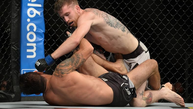 August 17, 2019; Anaheim, CA, USA; Cory Sandhegen lands a hit against Raphael Assuncao during UFC 241 at Honda Center. Mandatory Credit: Gary A. Vasquez-USA TODAY Sports