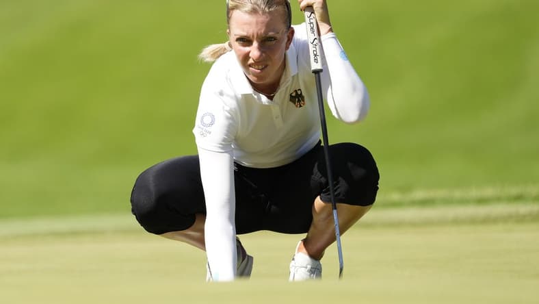 Aug 5, 2021; Tokyo, Japan; Sophia Popov (GER) prepares to putt on the fourth green during the second round of the women's individual stroke play of the Tokyo 2020 Olympic Summer Games at Kasumigaseki Country Club. Mandatory Credit: Michael Madrid-USA TODAY Sports