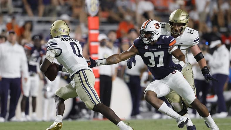 Sep 4, 2021; Auburn, Alabama, USA; Akron Zips quarterback DJ Irons (0) avoids Auburn Tigers edge Romello Height (37) during the fourth quarter at Jordan-Hare Stadium. Mandatory Credit: John Reed-USA TODAY Sports