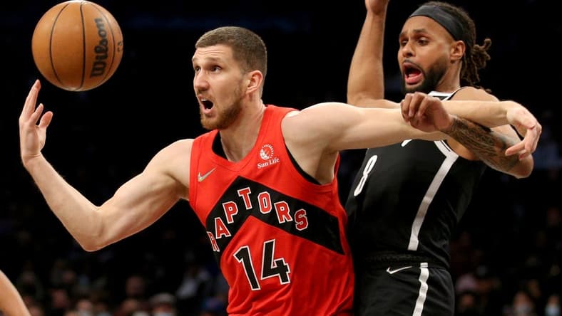 Dec 14, 2021; Brooklyn, New York, USA; Toronto Raptors guard Svi Mykhailiuk (14) loses the ball as he drives to the basket against Brooklyn Nets guard Patty Mills (8) during the first quarter at Barclays Center. Mandatory Credit: Brad Penner-USA TODAY Sports