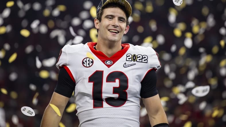 Jan 10, 2022; Indianapolis, IN, USA; Georgia Bulldogs quarterback Stetson Bennett (13) celebrates after defeating the Alabama Crimson Tide in the 2022 CFP college football national championship game at Lucas Oil Stadium. Mandatory Credit: Mark J. Rebilas-USA TODAY Sports