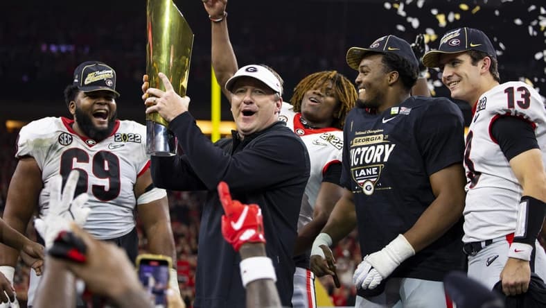 Jan 10, 2022; Indianapolis, IN, USA; Georgia Bulldogs head coach Kirby Smart celebrates with the championship trophy after defeating the Alabama Crimson Tide in the 2022 CFP college football national championship game at Lucas Oil Stadium. Mandatory Credit: Mark J. Rebilas-USA TODAY Sports