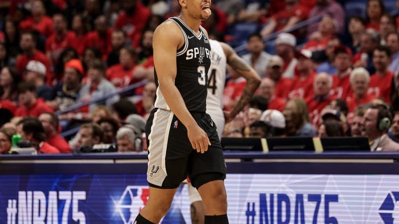 Apr 13, 2022; New Orleans, Louisiana, USA; San Antonio Spurs forward Keldon Johnson (3) reacts to a play against the New Orleans Pelicans during the first half of a play-in playoff game at the Smoothie King Center. Mandatory Credit: Stephen Lew-USA TODAY Sports