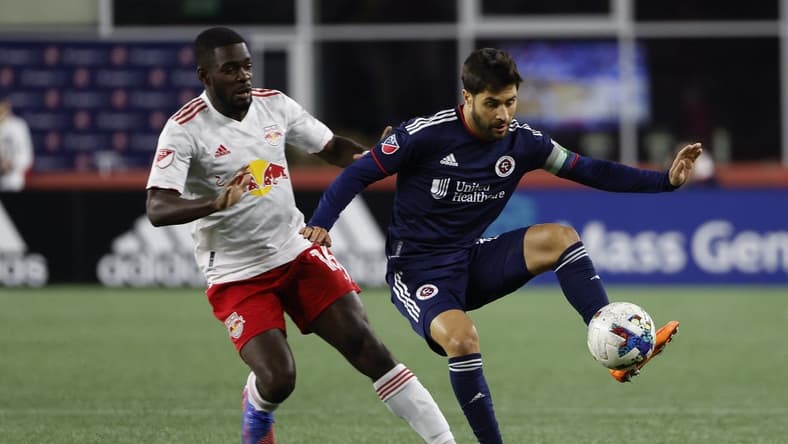 Apr 2, 2022; Foxborough, Massachusetts, USA; New England Revolution midfielder Carles Gil (10) controls the ball in front of New York Red Bulls midfielder Dru Yearwood (16) during the first half at Gillette Stadium. Mandatory Credit: Winslow Townson-USA TODAY Sports