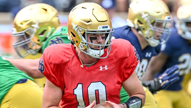 Apr 23, 2022; Notre Dame, Indiana, USA; Notre Dame Fighting Irish quarterback Drew Pyne (10) looks to hand off in the first quarter of the Blue-Gold Game at Notre Dame Stadium. Mandatory Credit: Matt Cashore-USA TODAY Sports