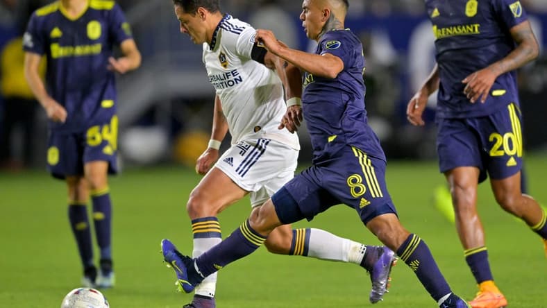 Apr 23, 2022; Carson, California, USA; Los Angeles Galaxy forward Javier Hernandez (14) and Nashville SC midfielder Randall Leal (8) battle for the ball in the second half at Dignity Health Sports Park. Mandatory Credit: Jayne Kamin-Oncea-USA TODAY Sports