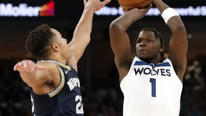 Apr 26, 2022; Memphis, Tennessee, USA; Memphis Grizzlies guard Desmond Bane (22) guards Minnesota Timberwolves forward Anthony Edwards (1) as he shoots the ball during the second half of game five of the first round for the 2022 NBA playoffs at FedExForum. Mandatory Credit: Christine Tannous-USA TODAY Sports