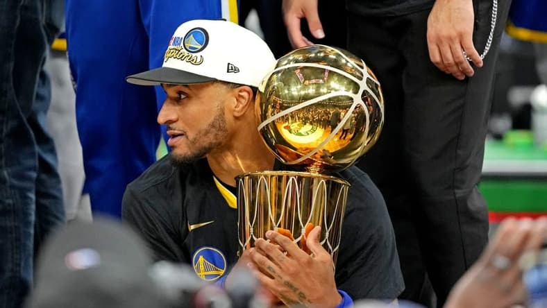 Jun 16, 2022; Boston, Massachusetts, USA; Golden State Warriors guard Gary Payton II (0) holds the the Larry O'Brien Championship Trophy after the Golden State Warriors beat the Boston Celtics in game six of the 2022 NBA Finals to win the NBA Championship at TD Garden. Mandatory Credit: Kyle Terada-USA TODAY Sports