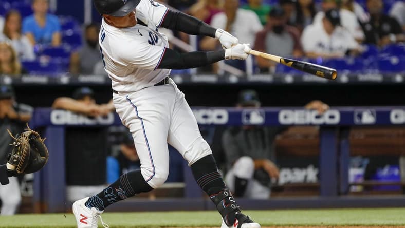 Jul 14, 2022; Miami, Florida, USA; Miami Marlins designated hitter Avisail Garcia (24) hits a single in the eleventh inning against the Pittsburgh Pirates at loanDepot Park. Mandatory Credit: Sam Navarro-USA TODAY Sports