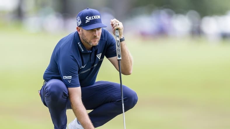 Jul 31, 2022; Detroit, Michigan, USA; Taylor Pendrith places his ball on the green on the par 4 first hole during the final round of the Rocket Mortgage Classic golf tournament. Mandatory Credit: Raj Mehta-USA TODAY Sports