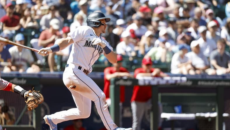 Aug 6, 2022; Seattle, Washington, USA; Seattle Mariners center fielder Jarred Kelenic (10) hits a single against the Los Angeles Angels during the fifth inning at T-Mobile Park. Mandatory Credit: Joe Nicholson-USA TODAY Sports