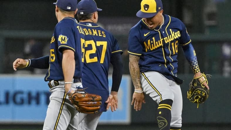 Aug 13, 2022; St. Louis, Missouri, USA;  Milwaukee Brewers second baseman Kolten Wong (16) celebrates with shortstop Willy Adames (27) after the Brewers defeated the St. Louis Cardinals in ten innings at Busch Stadium. Mandatory Credit: Jeff Curry-USA TODAY Sports