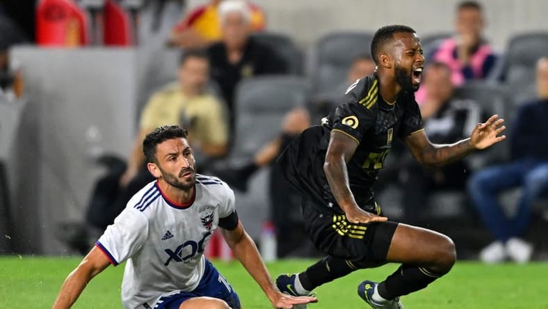 Aug 16, 2022; Los Angeles, California, USA; D.C. United defender Steve Birnbaum (15) is shown a red card for a second caution by referee Ramy Touchan (not pictured) at after a foul on LAFC midfielder Kellyn Acosta (23) in the second half of the game at Banc of California Stadium. Mandatory Credit: Jayne Kamin-Oncea-USA TODAY Sports