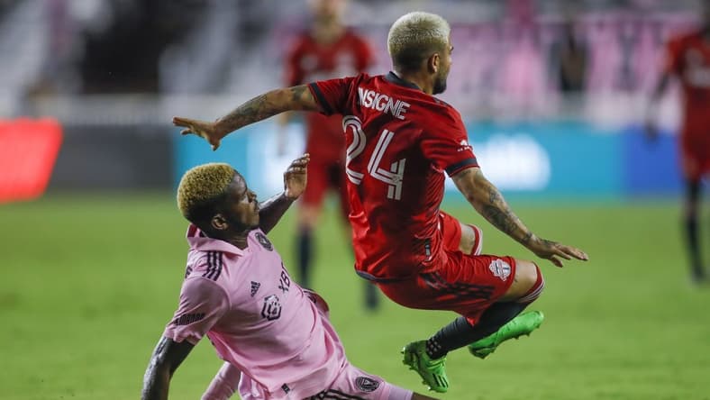 Aug 20, 2022; Fort Lauderdale, Florida, USA; Toronto FC forward Lorenzo Insigne (24) gets fouled by Inter Miami CF defender DeAndre Yedlin (2) during the second half at DRV PNK Stadium. Mandatory Credit: Sam Navarro-USA TODAY Sports