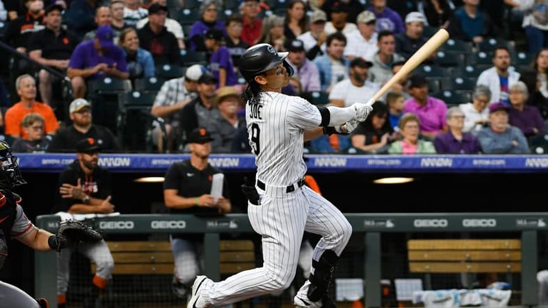 Aug 20, 2022; Denver, Colorado, USA; Colorado Rockies left fielder Connor Joe (9) looks up at the ball during his at bat agains the San Francisco Giants at Coors Field. Mandatory Credit: John Leyba-USA TODAY Sports