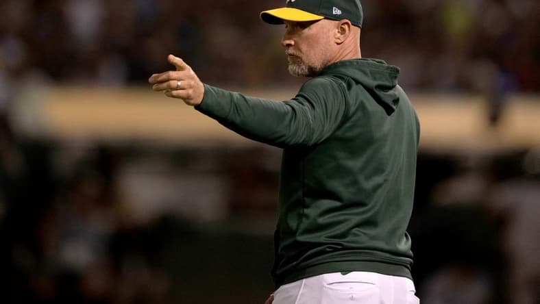 Aug 25, 2022; Oakland, California, USA; Oakland Athletics manager Mark Kotsay (7) signals during the third inning against the New York Yankees at RingCentral Coliseum. Mandatory Credit: Stan Szeto-USA TODAY Sports