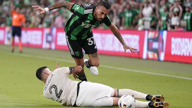Aug 26, 2022; Austin, Texas, USA; Los Angeles FC defender Franco Escobar (2) slide tackles Austin FC forward Maximiliano Urruti (37) during the second half at Q2 Stadium. Mandatory Credit: Scott Wachter-USA TODAY Sports