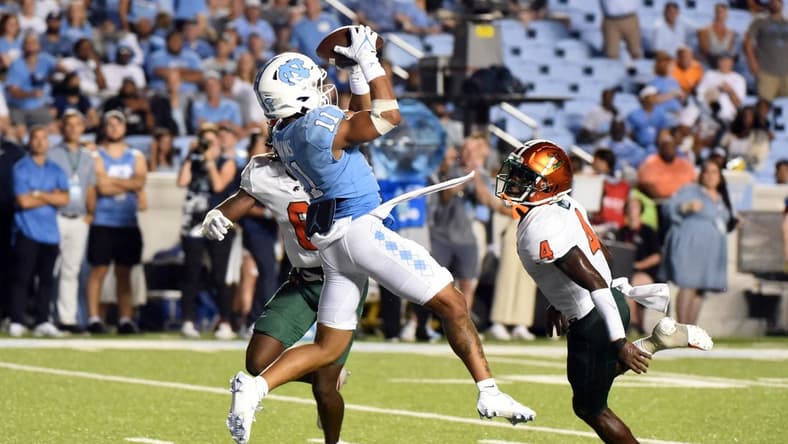 Aug 27, 2022; Chapel Hill, North Carolina, USA;North Carolina Tar Heels receiver Josh Downs (11) catches a touchdown pass during the second half against the Florida A&M Rattlers at Kenan Memorial Stadium. Mandatory Credit: Rob Kinnan-USA TODAY Sports