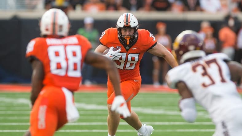 Sep 1, 2022; Stillwater, Oklahoma, USA; Oklahoma State Cowboys fullback Jake Schultz (38) turns to run after a catch during the second quarter against the Central Michigan Chippewas at Boone Pickens Stadium. Mandatory Credit: Brett Rojo-USA TODAY Sports