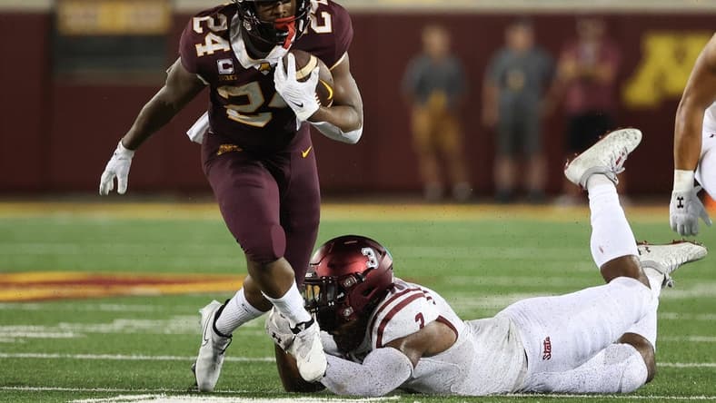 Sep 1, 2022; Minneapolis, Minnesota, USA; Minnesota Golden Gophers running back Mohamed Ibrahim (24) breaks a tackle from New Mexico State Aggies linebacker Chris Ojoh (3) during the first quarter at Huntington Bank Stadium. Mandatory Credit: Matt Krohn-USA TODAY Sports