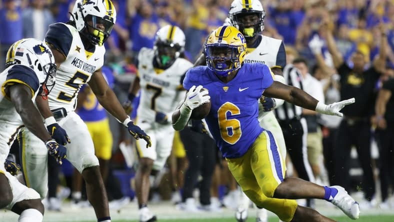 Sep 1, 2022; Pittsburgh, Pennsylvania, USA;  Pittsburgh Panthers running back Rodney Hammond Jr. (6) runs after a catch as West Virginia Mountaineers linebacker Lance Dixon (5) and cornerback Wesley McCormick (11) chase during the third quarter at Acrisure Stadium. Pittsburgh won 38-31. Mandatory Credit: Charles LeClaire-USA TODAY Sports
