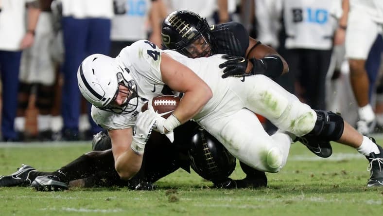 Purdue Boilermakers linebacker Clyde Washington (42) and Purdue Boilermakers safety Chris Jefferson (17) tackle Penn State Nittany Lions tight end Tyler Warren (44) during the NCAA football game, Thursday, Sept. 1, 2022, at Ross-Ade Stadium in West Lafayette, Ind. Penn State won 35-31.

Purduepennstatefb090122 Am01374
