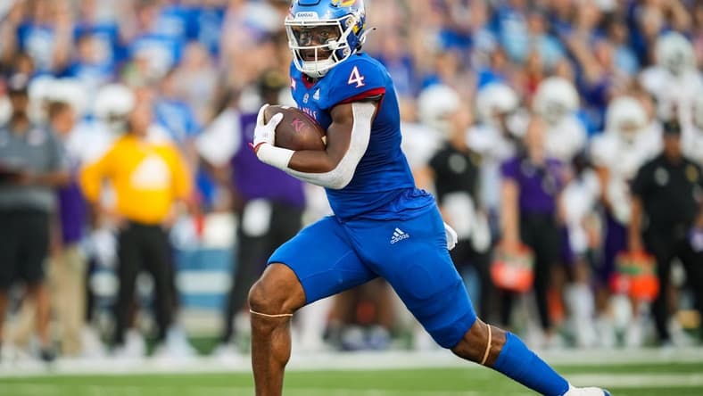 Sep 2, 2022; Lawrence, Kansas, USA; Kansas Jayhawks running back Devin Neal (4) runs for a touchdown against the Tennessee Tech Golden Eagles during the first half at David Booth Kansas Memorial Stadium. Mandatory Credit: Jay Biggerstaff-USA TODAY Sports