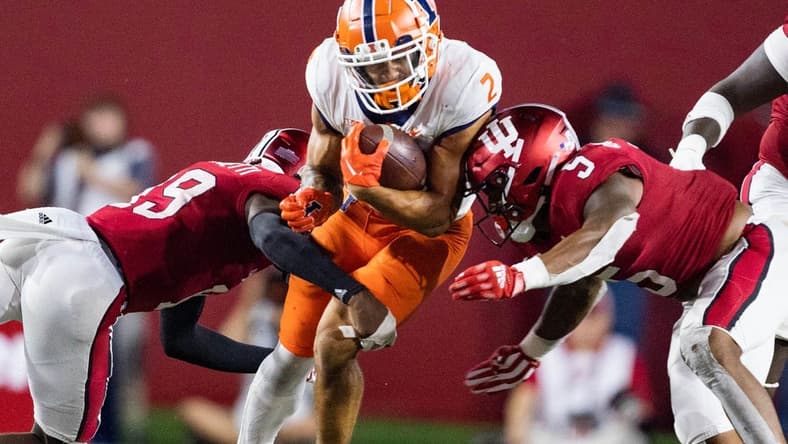 Sep 2, 2022; Bloomington, Indiana, USA; Illinois Fighting Illini running back Chase Brown (2) runs the ball while Indiana Hoosiers defensive back Josh Sanguinetti (19) defends in the second half at Memorial Stadium. Mandatory Credit: Trevor Ruszkowski-USA TODAY Sports
