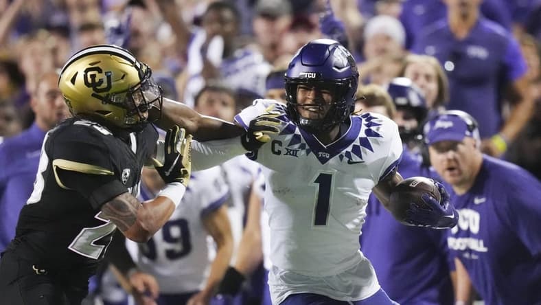 Sep 2, 2022; Boulder, Colorado, USA; TCU Horned Frogs wide receiver Quentin Johnston (1) stiff arms Colorado Buffaloes safety Isaiah Lewis (23) in the second quarter at Folsom Field. Mandatory Credit: Ron Chenoy-USA TODAY Sports
