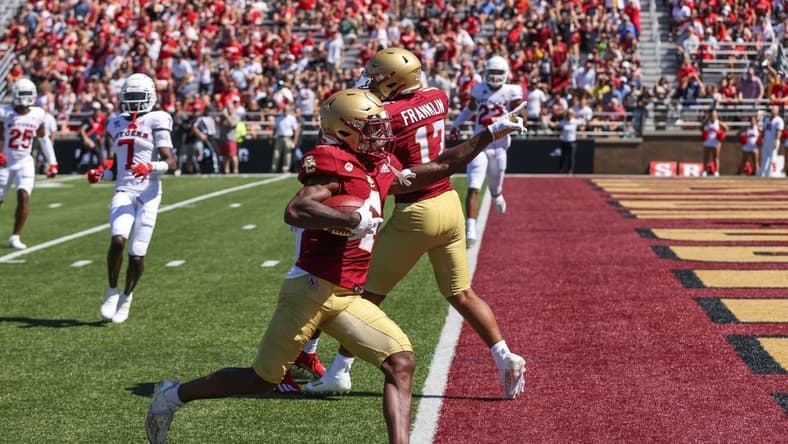 Sep 3, 2022; Chestnut Hill, Massachusetts, USA; Boston College Eagles receiver Zay Flowers (4) scores a touchdown during the first half against the Rutgers Scarlet Knights at Alumni Stadium. Mandatory Credit: Paul Rutherford-USA TODAY Sports
