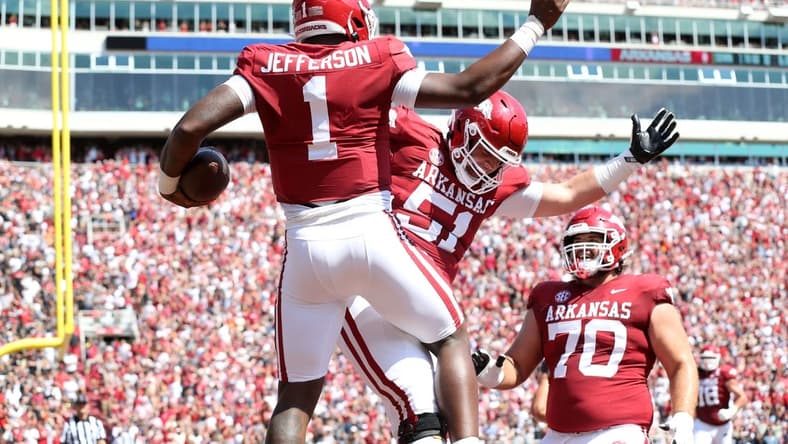 Sep 3, 2022; Fayetteville, Arkansas, USA; Arkansas Razorbacks quarterback KJ Jefferson (1) celebrates with offensive lineman Ricky Stromberg (51) and Luke Jones (70) after rushing for a touchdown in the first quarter against the Cincinnati Bearcats at Donald W. Reynolds Razorback Stadium. Mandatory Credit: Nelson Chenault-USA TODAY Sports