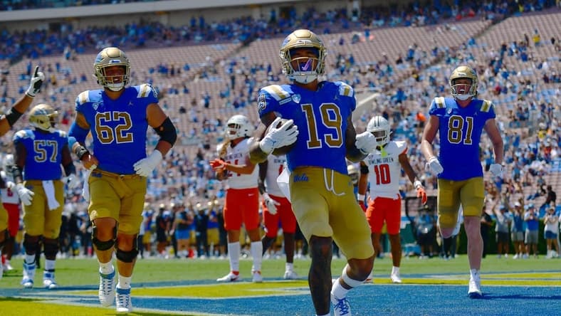 Sep 3, 2022; Pasadena, California, USA; UCLA Bruins wide receiver Kazmeir Allen (19) scores a touchdown against the Bowling Green Falcons during the first half at Rose Bowl. Mandatory Credit: Gary A. Vasquez-USA TODAY Sports