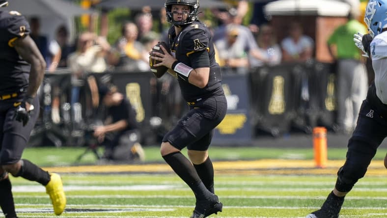 Sep 3, 2022; Boone, North Carolina, USA; Appalachian State Mountaineers quarterback Chase Brice (7) looks down field for a receiver against the North Carolina Tar Heels during the second half at Kidd Brewer Stadium. Mandatory Credit: Jim Dedmon-USA TODAY Sports