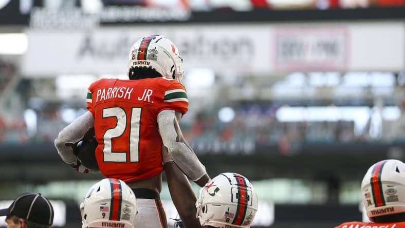Sep 3, 2022; Miami Gardens, Florida, USA; Miami Hurricanes running back Henry Parrish Jr. (21) celebrates with teammates after scoring during the second quarter against the Bethune Cookman Wildcats at Hard Rock Stadium. Mandatory Credit: Sam Navarro-USA TODAY Sports