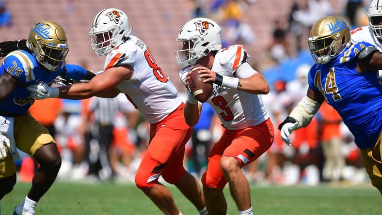 Sep 3, 2022; Pasadena, California, USA; Bowling Green Falcons quarterback Matt McDonald (3) runs the ball as UCLA Bruins defensive lineman Martin Andrus Jr. (44)  and linebacker Carl Jones Jr. (35) move in with tight end Andrew Bench (89) providing coverage during the second half at Rose Bowl. Mandatory Credit: Gary A. Vasquez-USA TODAY Sports