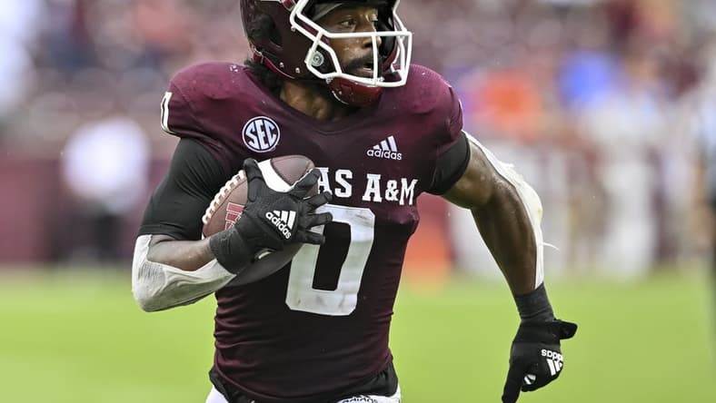 Sep 3, 2022; College Station, Texas, USA;  Texas A&M Aggies wide receiver Ainias Smith (0) runs the ball in for a touchdown during the third quarter against the Sam Houston State Bearkats at Kyle Field. Mandatory Credit: Maria Lysaker-USA TODAY Sports