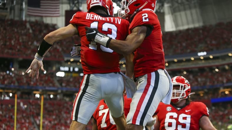 Sep 3, 2022; Atlanta, Georgia, USA; Georgia Bulldogs quarterback Stetson Bennett (13) celebrates with running back Kendall Milton (2) after a touchdown run against the Oregon Ducks in the second quarter at Mercedes-Benz Stadium. Mandatory Credit: Brett Davis-USA TODAY Sports
