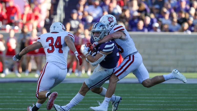 Sep 3, 2022; Manhattan, Kansas, USA; Kansas State Wildcats tight end Ben Sinnott (34) is tackled by South Dakota Coyotes linebacker Stephen Hillis (34) and South Dakota Coyotes linebacker Gage Tennyson (38) during the first quarter at Bill Snyder Family Football Stadium. Mandatory Credit: Scott Sewell-USA TODAY Sports