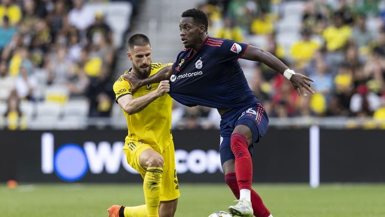 Sep 3, 2022; Columbus, Ohio, USA; Columbus Crew defender Milos Degenek (5) tries to pull Chicago Fire forward Jhon Duran (26) off the ball in the second half at Lower.com Field. Mandatory Credit: Greg Bartram-USA TODAY Sports