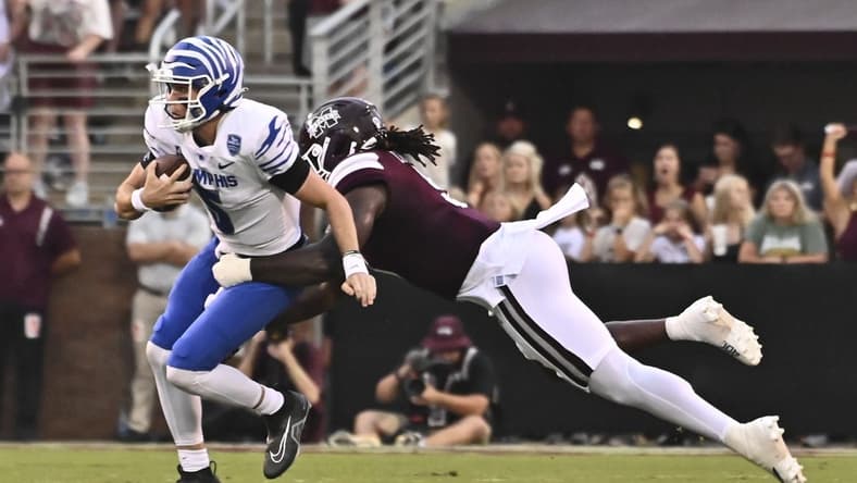 Sep 3, 2022; Starkville, Mississippi, USA; Memphis Tigers quarterback Seth Henigan (5) is sacked by Mississippi State Bulldogs defensive end Randy Charlton (5) during the first quarter at Davis Wade Stadium at Scott Field. Mandatory Credit: Matt Bush-USA TODAY Sports