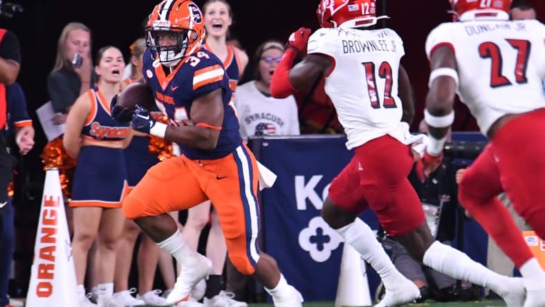 Sep 3, 2022; Syracuse, New York, USA; Syracuse Orange running back Sean Tucker (34) runs against Louisville Cardinals cornerback Jarvis Brownlee (12) in the first quarter at JMA Wireless Dome. Mandatory Credit: Mark Konezny-USA TODAY Sports