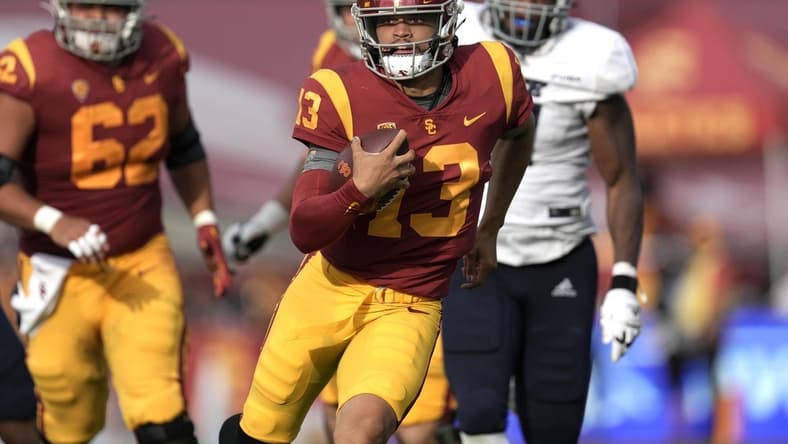Sep 3, 2022; Los Angeles, California, USA; Southern California Trojans quarterback Caleb Williams (13) carries the ball against the Rice Owls in the second half at United Airlines Field at Los Angeles Memorial Coliseum. Mandatory Credit: Kirby Lee-USA TODAY Sports