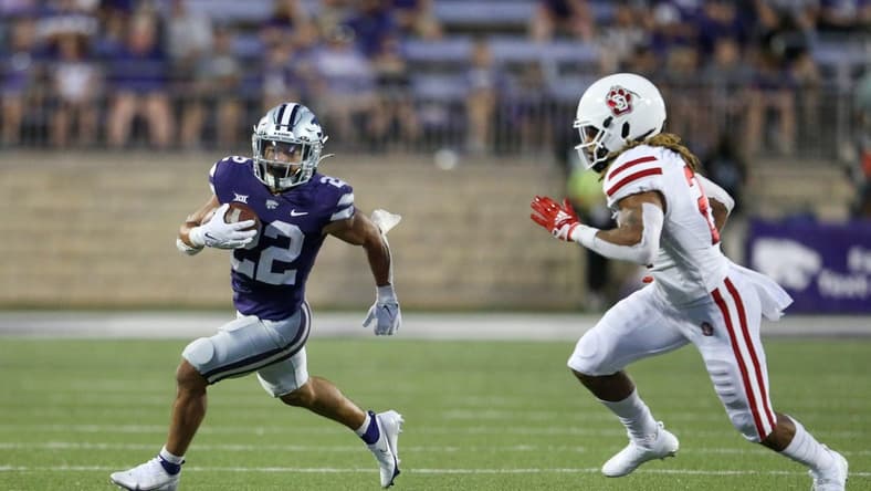 Sep 3, 2022; Manhattan, Kansas, USA; Kansas State Wildcats running back Deuce Vaughn (22) is chased by South Dakota Coyotes linebacker Tre Thomas (21) during the second quarter at Bill Snyder Family Football Stadium. Mandatory Credit: Scott Sewell-USA TODAY Sports