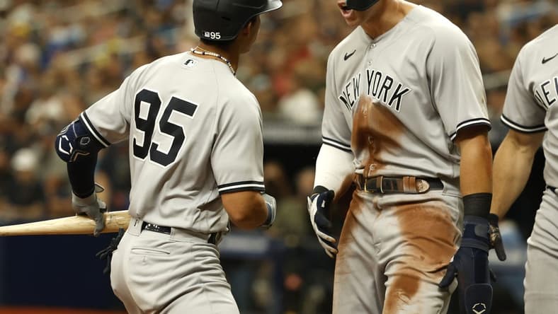 Sep 4, 2022; St. Petersburg, Florida, USA; New York Yankees right fielder Aaron Judge (99) celebrates as he scores a run on shortstop Oswaldo Cabrera (95) sacrifice RBI against the Tampa Bay Rays during the seventh inning at Tropicana Field. Mandatory Credit: Kim Klement-USA TODAY Sports
