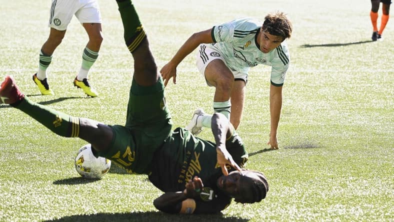 Sep 4, 2022; Portland, Oregon, USA;  Atlanta United midfielder Santiago Sosa (5) fouls Portland Timbers midfielder Diego Chara (21) during the second half setting up a penalty kick at Providence Park. The Timbers won 2-1. Mandatory Credit: Troy Wayrynen-USA TODAY Sports